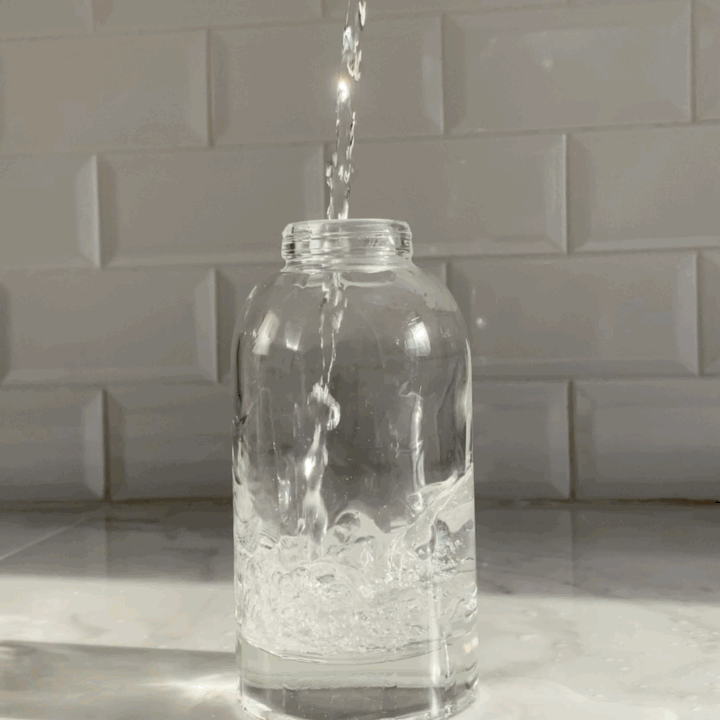 DIY hand soap refill dissolving in a glass foaming pump bottle